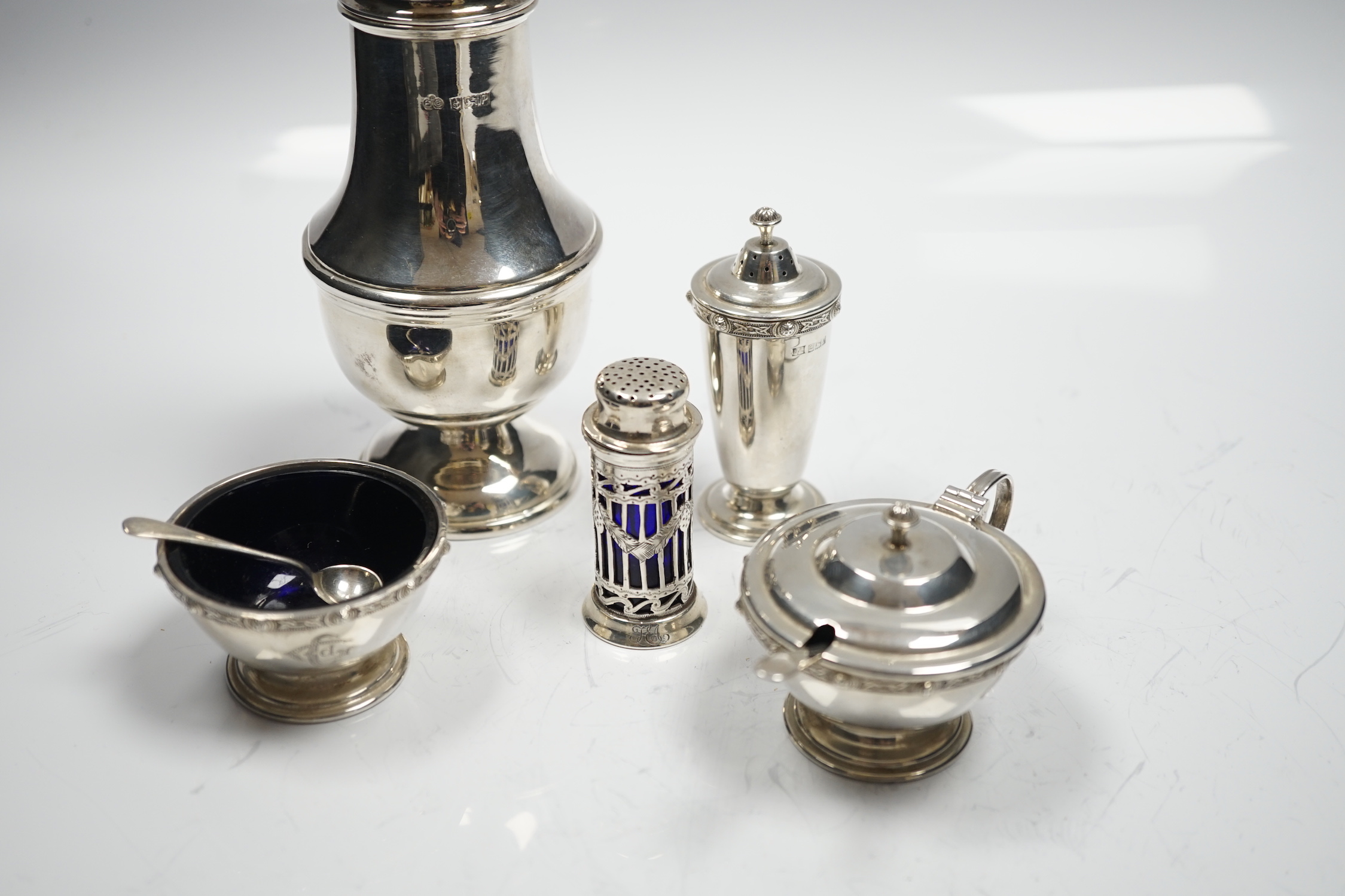 A modern silver baluster sugar caster by Elkington & Co and four assorted silver condiments.